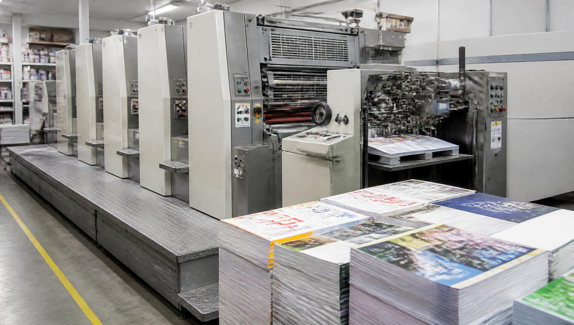 Offset printing press producing colourful printed advertising material